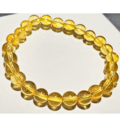 Yellow beaded bracelet on a white surface