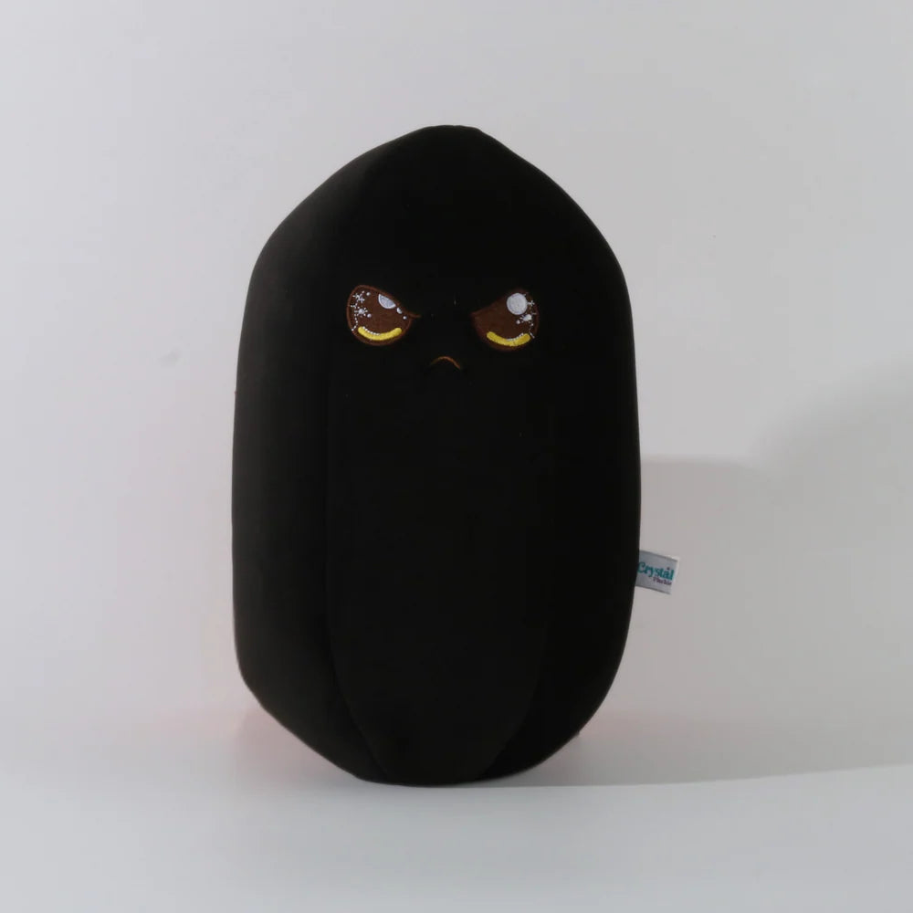 Black plush toy with angry face design on a white background