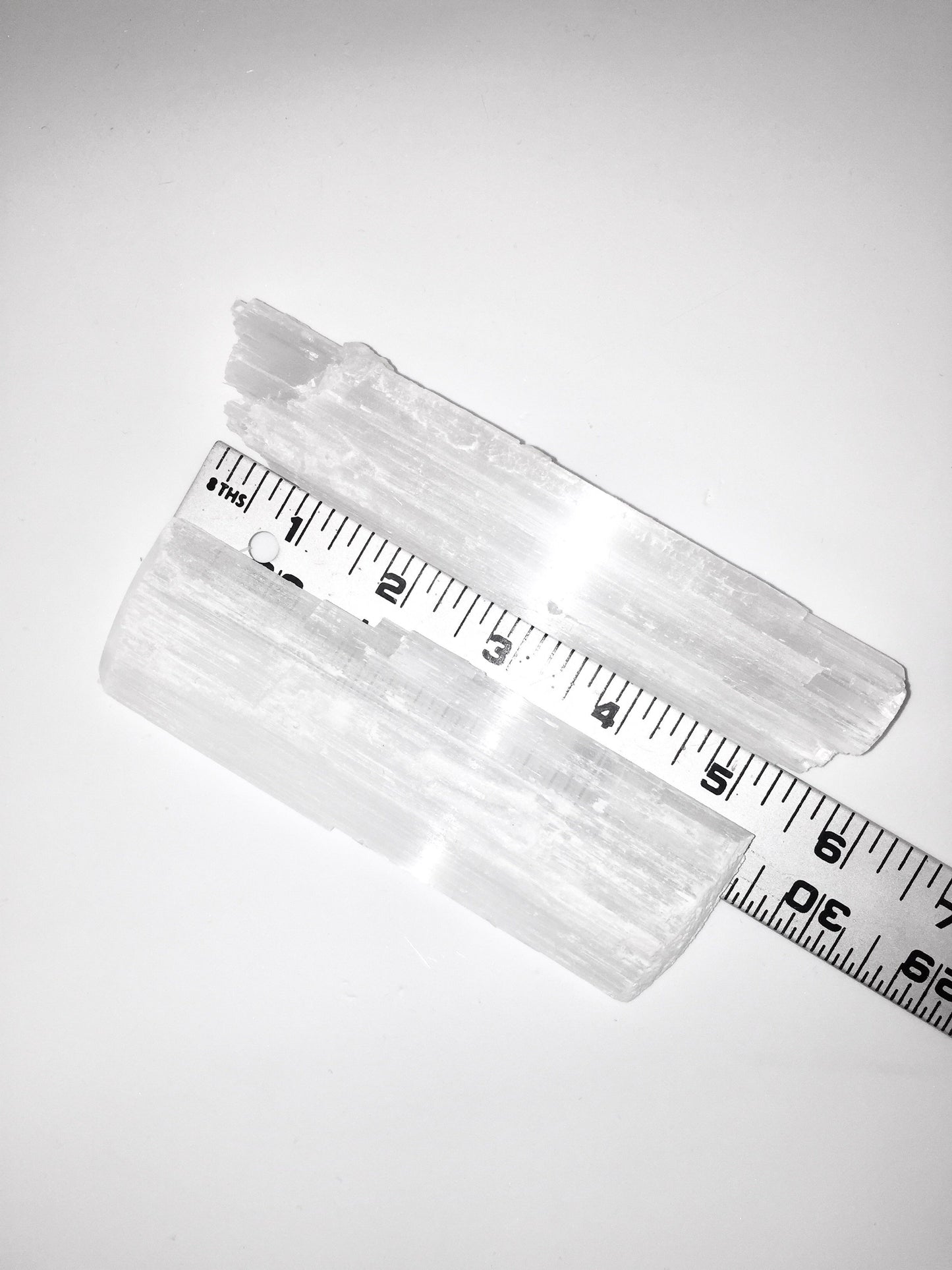 selenite crysta with a ruler showing 5 inches