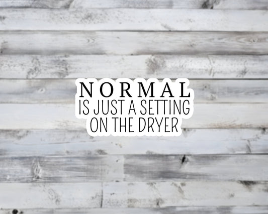 Text 'NORMAL IS JUST A SETTING ON THE DRYER' on a wooden background