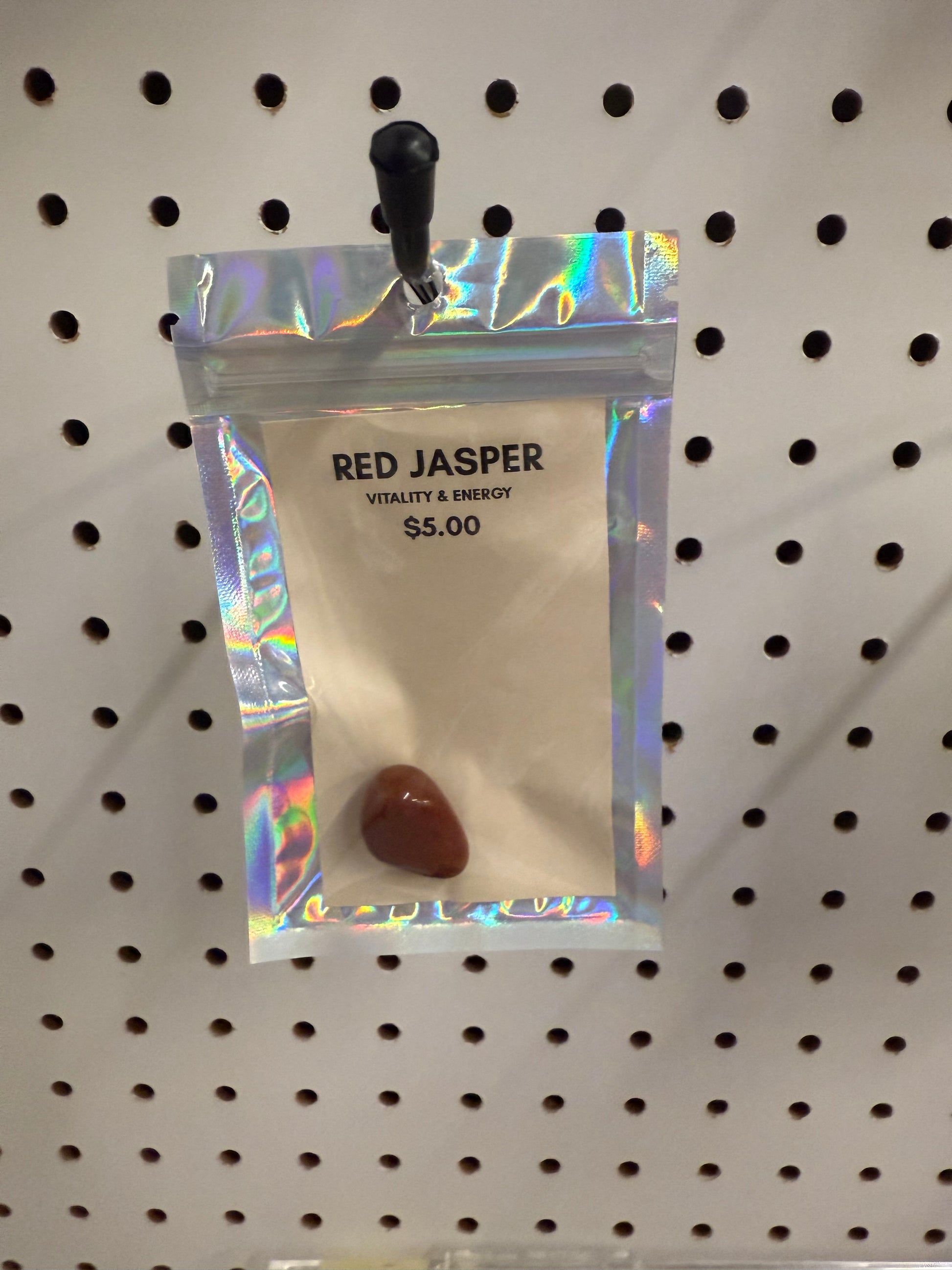 Red Jasper stone in a clear packaging on a pegboard